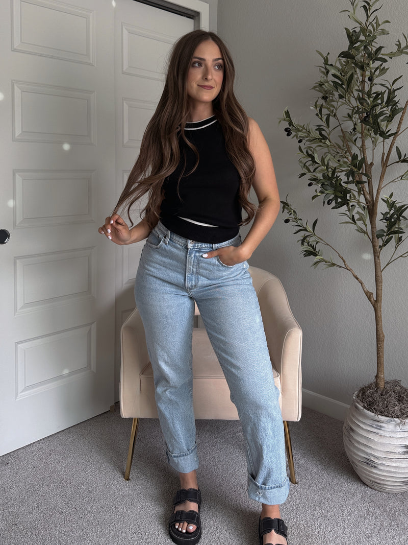Model wearing the Jolie Contrast Trim Knit Halter Top in black with white piping, styled with light wash jeans, spring outfit
